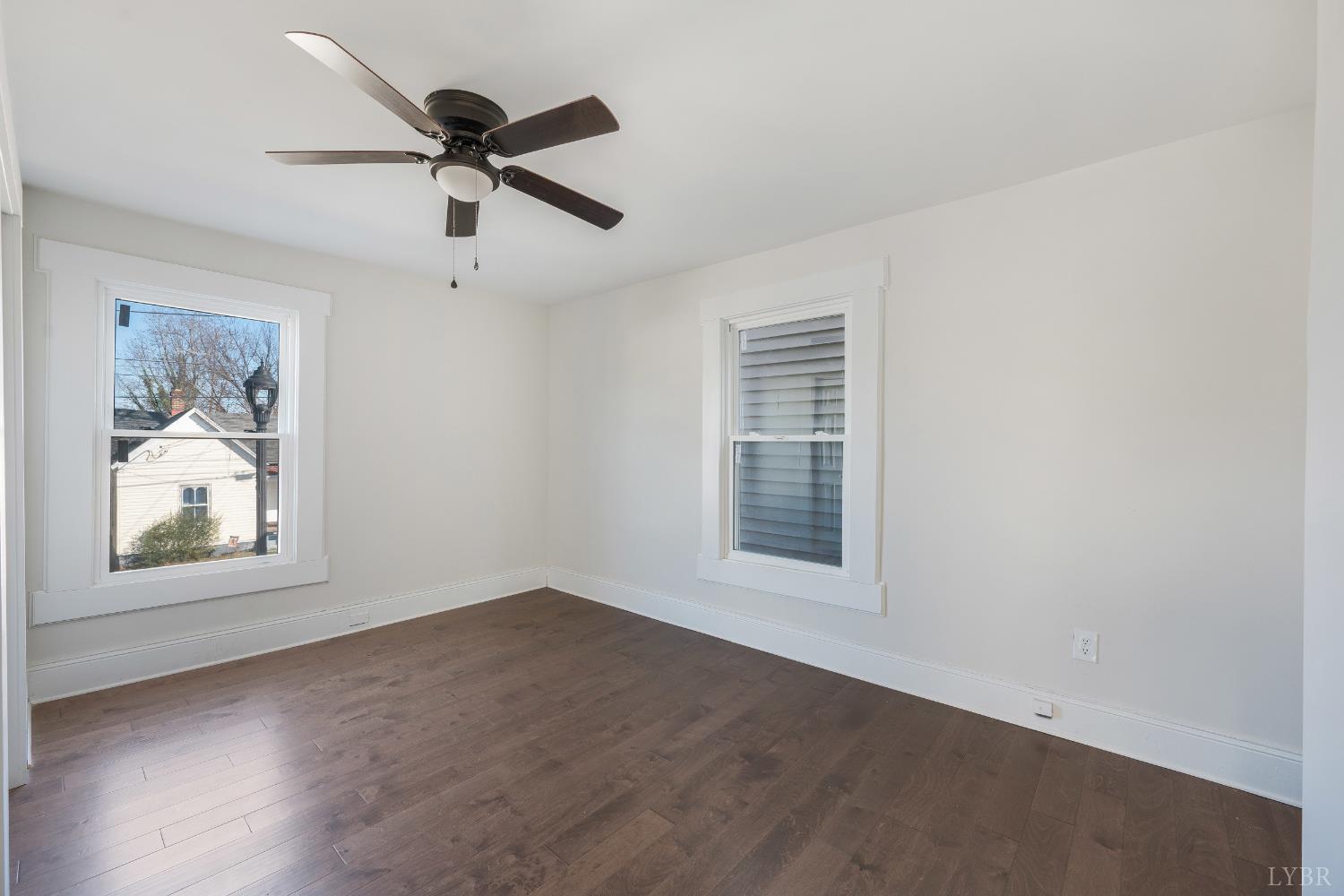 2927 Langhorne Road Lynchburg, VA 24501 - Photo 22 of 48 an empty room with wooden floor ceiling fan and windows