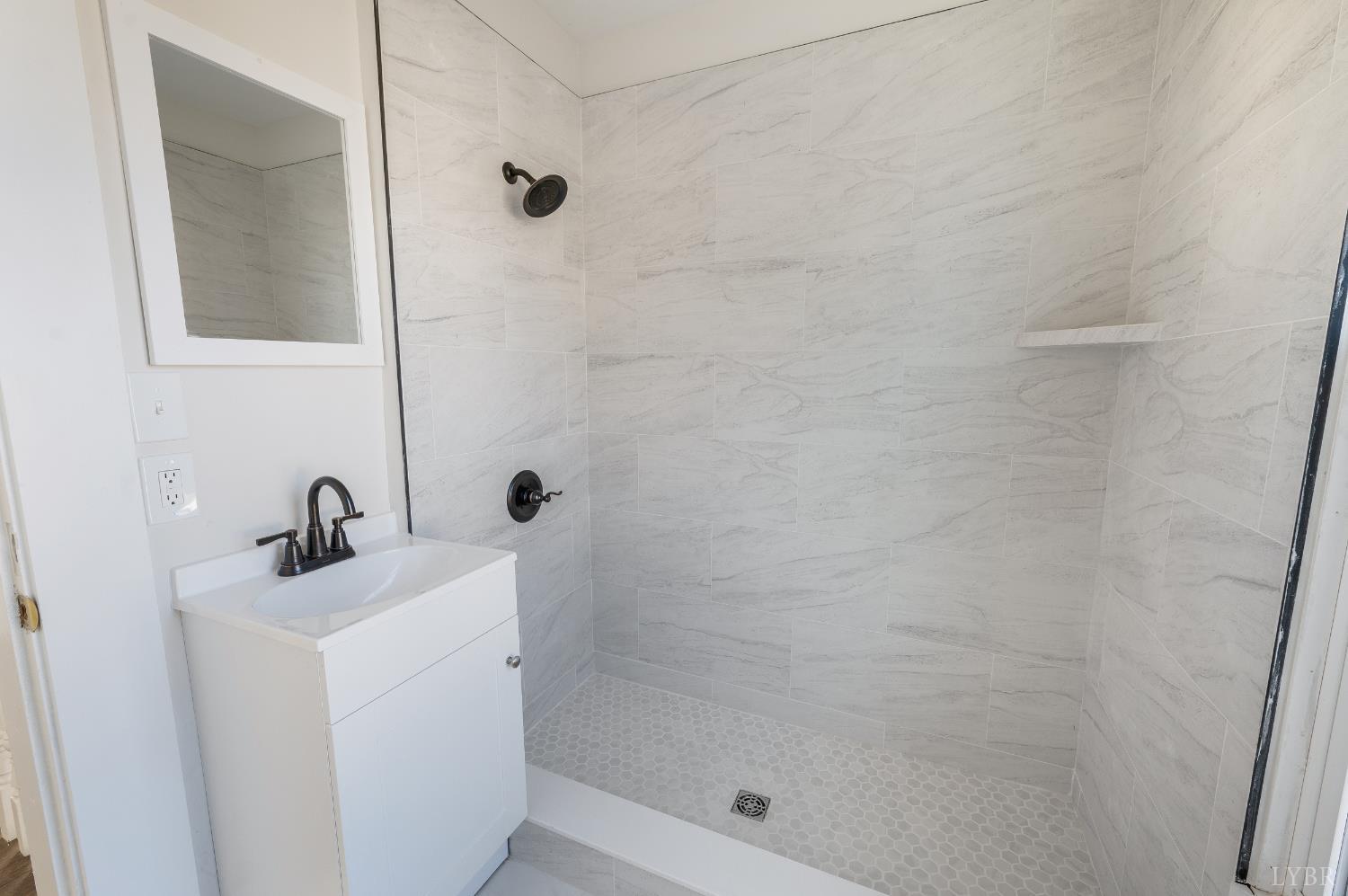 2927 Langhorne Road Lynchburg, VA 24501 - Photo 25 of 48 a bathroom with a sink a mirror and shower