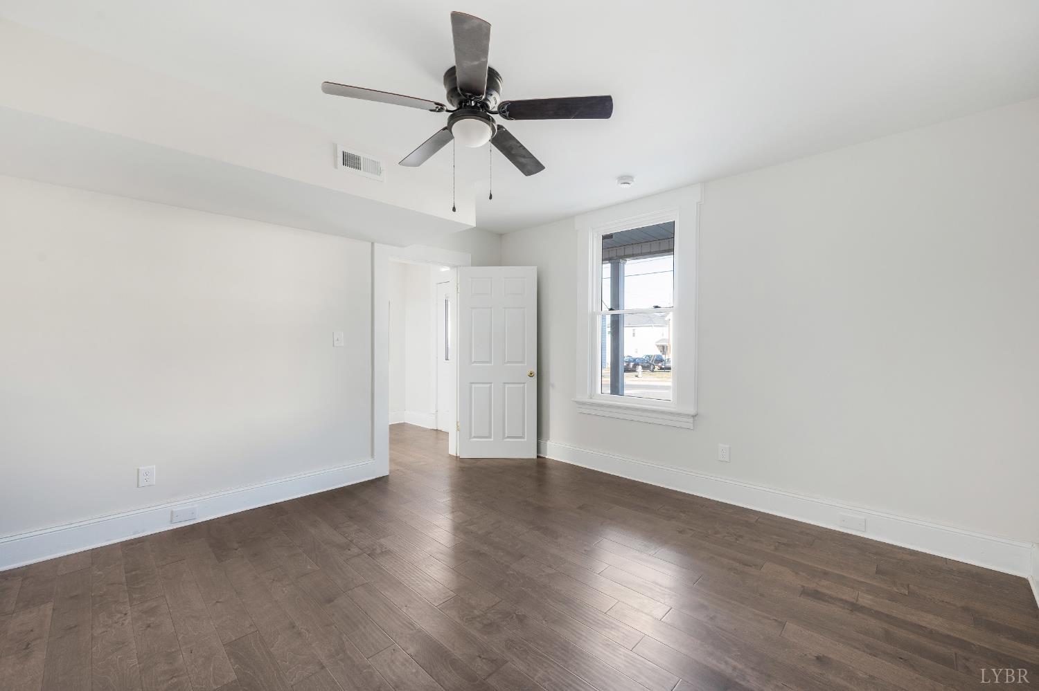2927 Langhorne Road Lynchburg, VA 24501 - Photo 6 of 48 a view of an empty room with wooden floor and a window