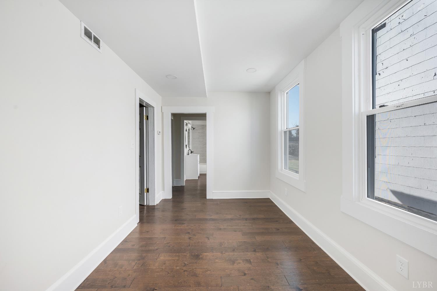 2927 Langhorne Road Lynchburg, VA 24501 - Photo 7 of 48 a view of an empty room with wooden floor and a window