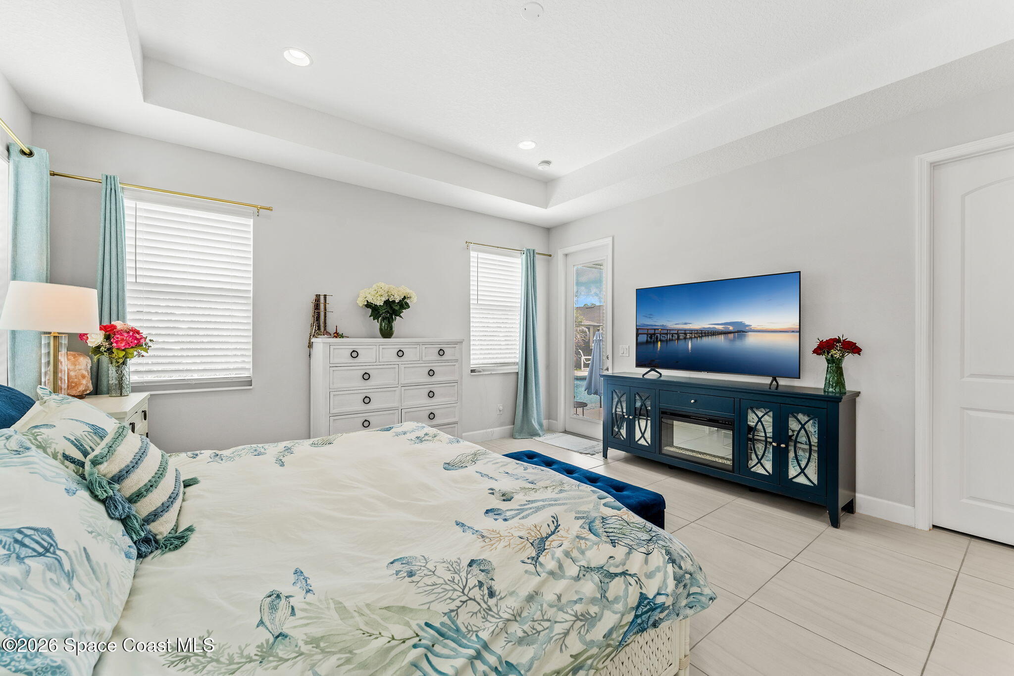3135 Addison Drive Melbourne, FL 32940 - Photo 19 of 51 a bedroom with a bed and a flat screen tv
