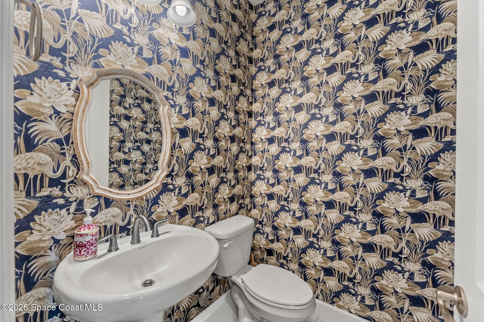 3135 Addison Drive Melbourne, FL 32940 - Photo 21 of 51 a bathroom with a sink toilet and mirror