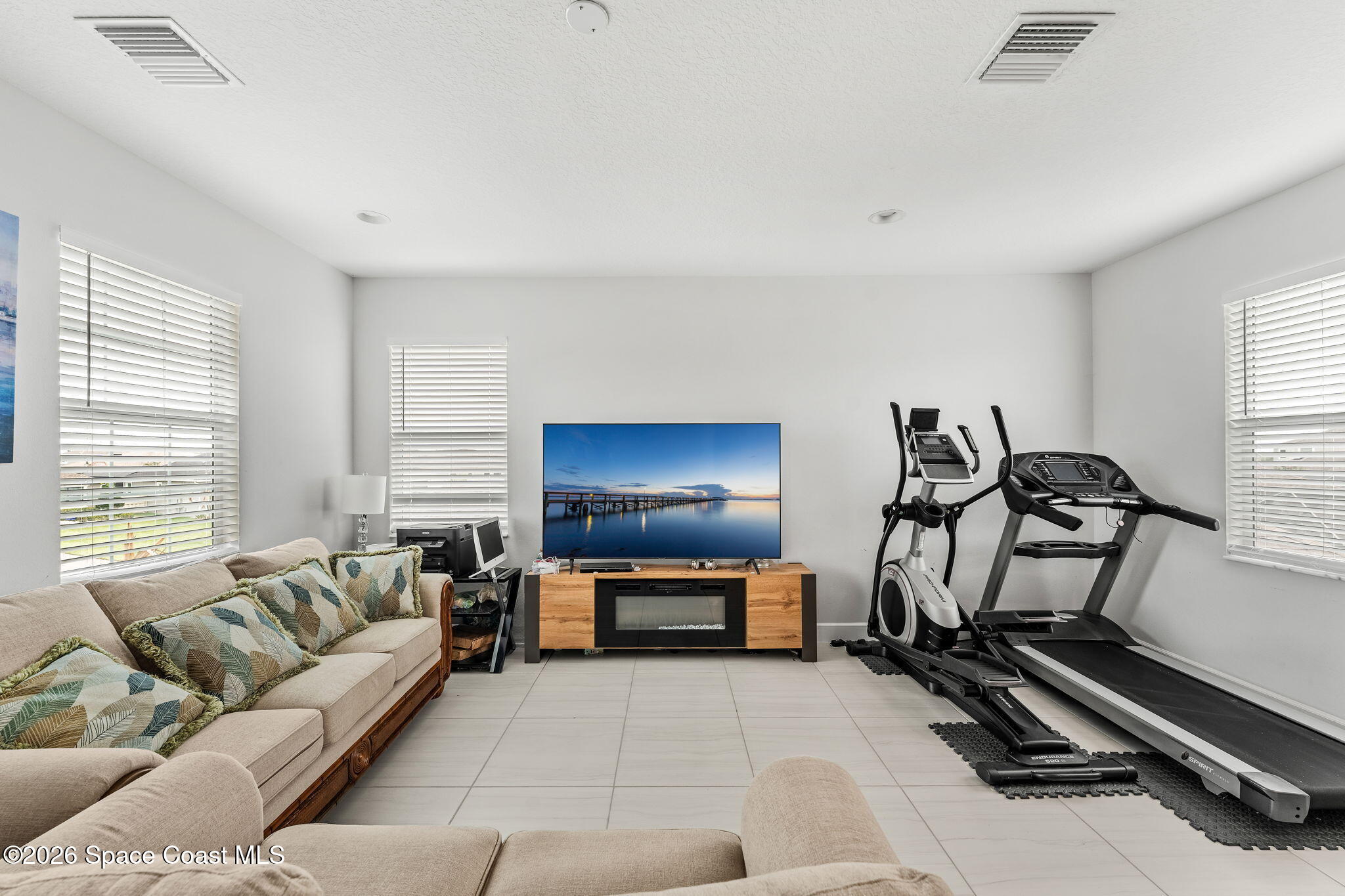 3135 Addison Drive Melbourne, FL 32940 - Photo 27 of 51 a living room with furniture and a flat screen tv