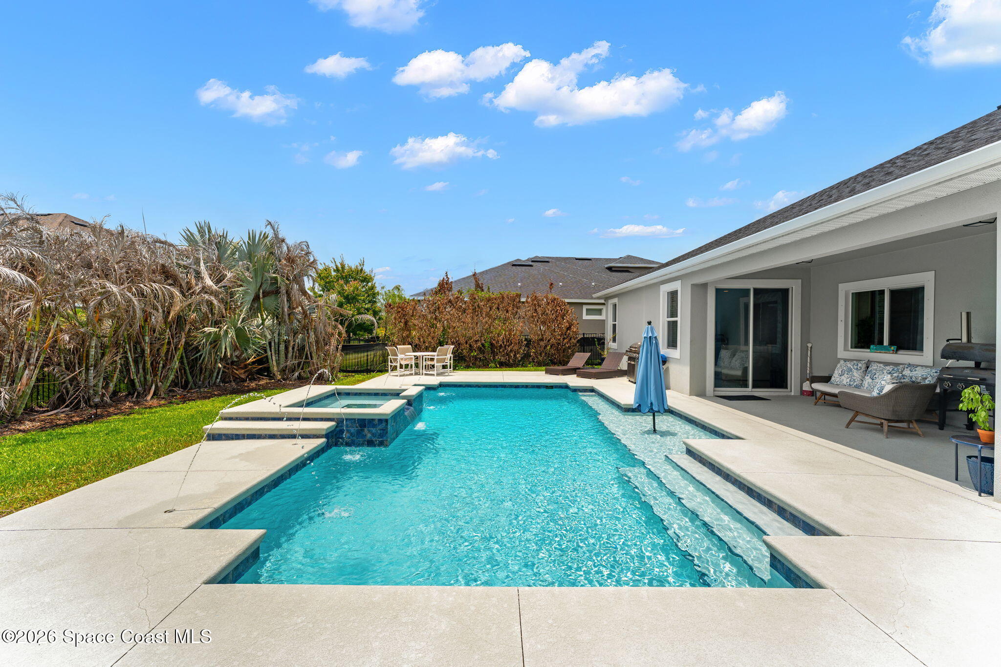 3135 Addison Drive Melbourne, FL 32940 - Photo 29 of 51 a view of a house with backyard porch and sitting area