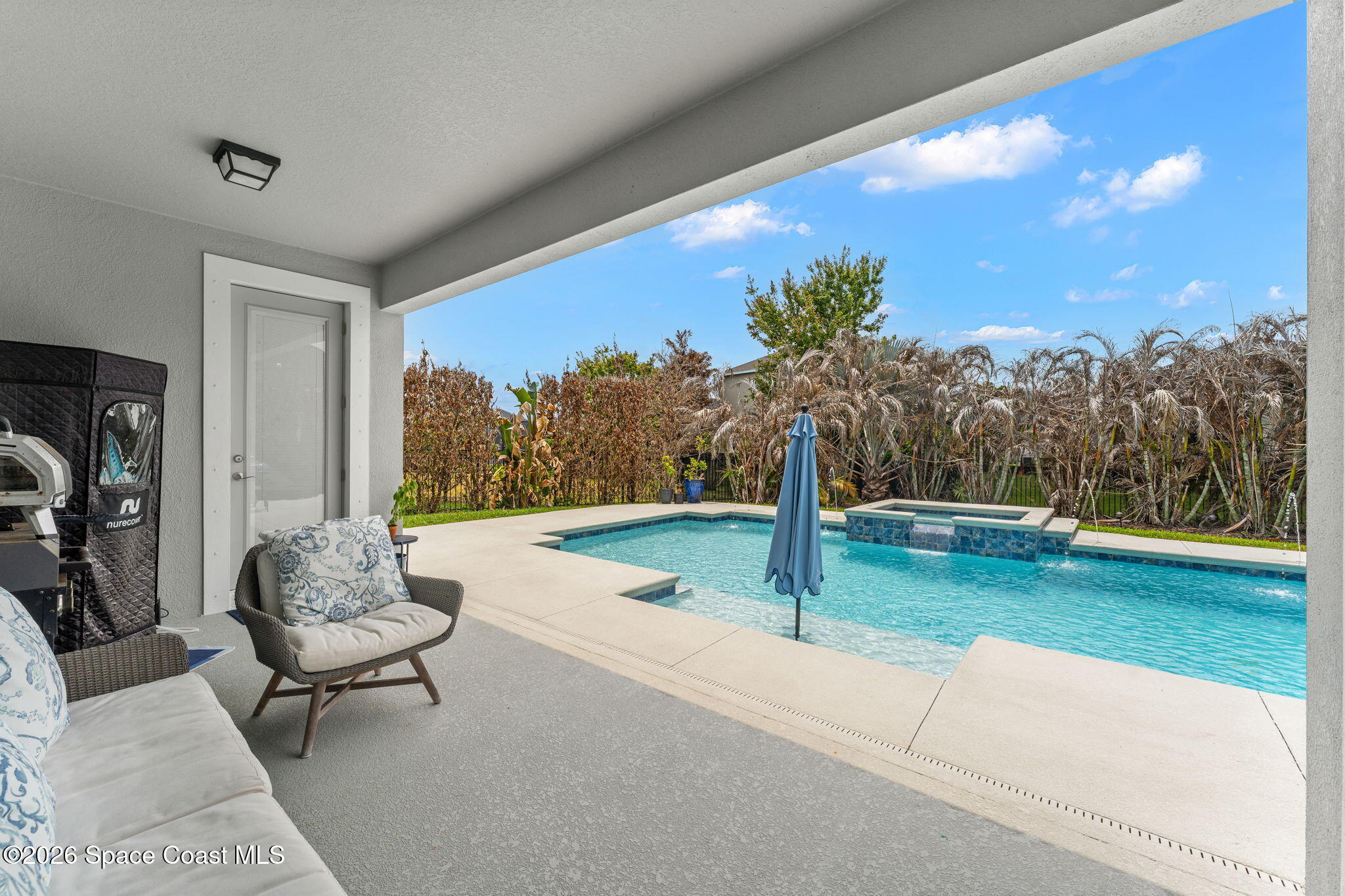 3135 Addison Drive Melbourne, FL 32940 - Photo 3 of 51 a living room with patio furniture and a floor to ceiling window