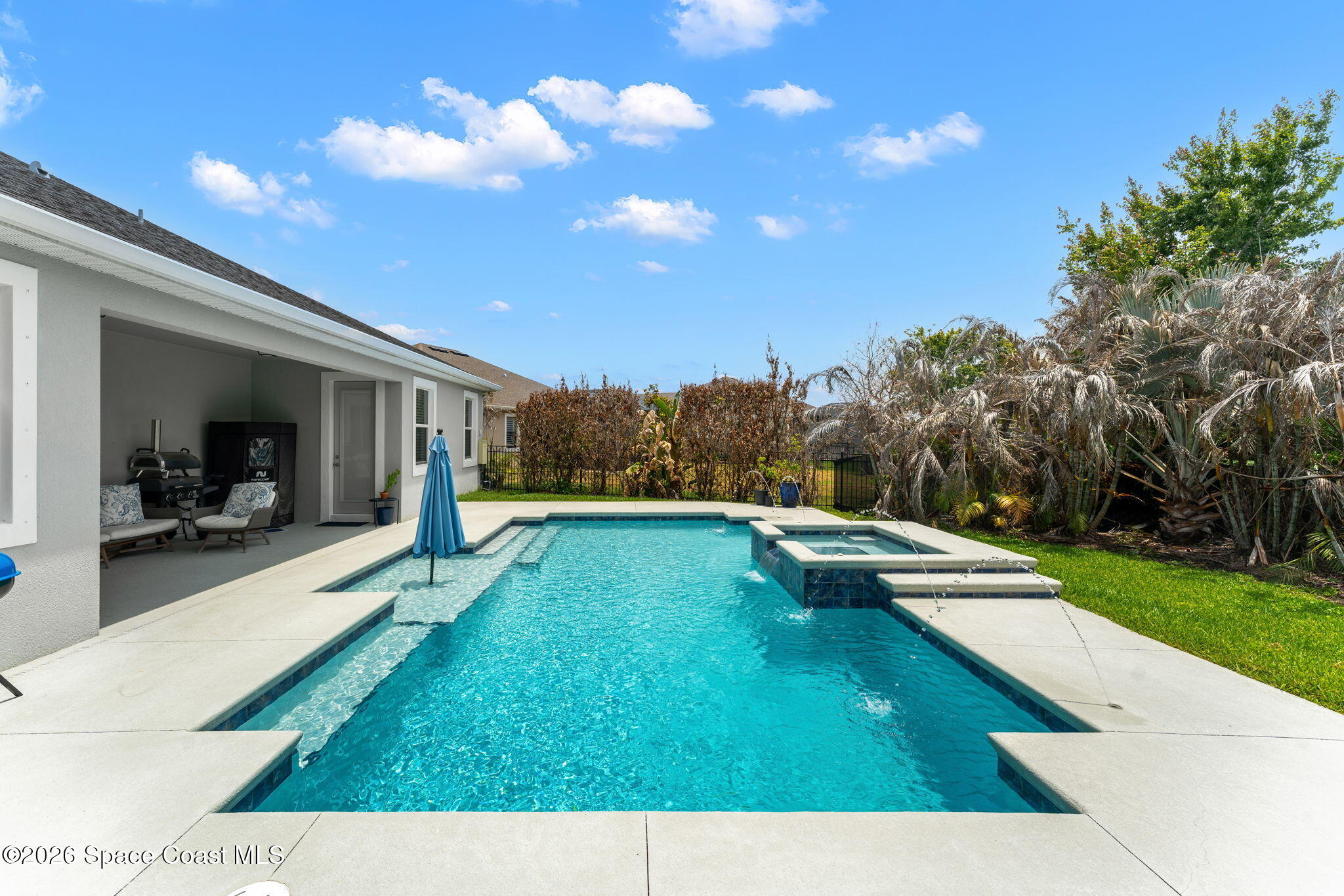 3135 Addison Drive Melbourne, FL 32940 - Photo 31 of 51 a view of a swimming pool and lounge chair