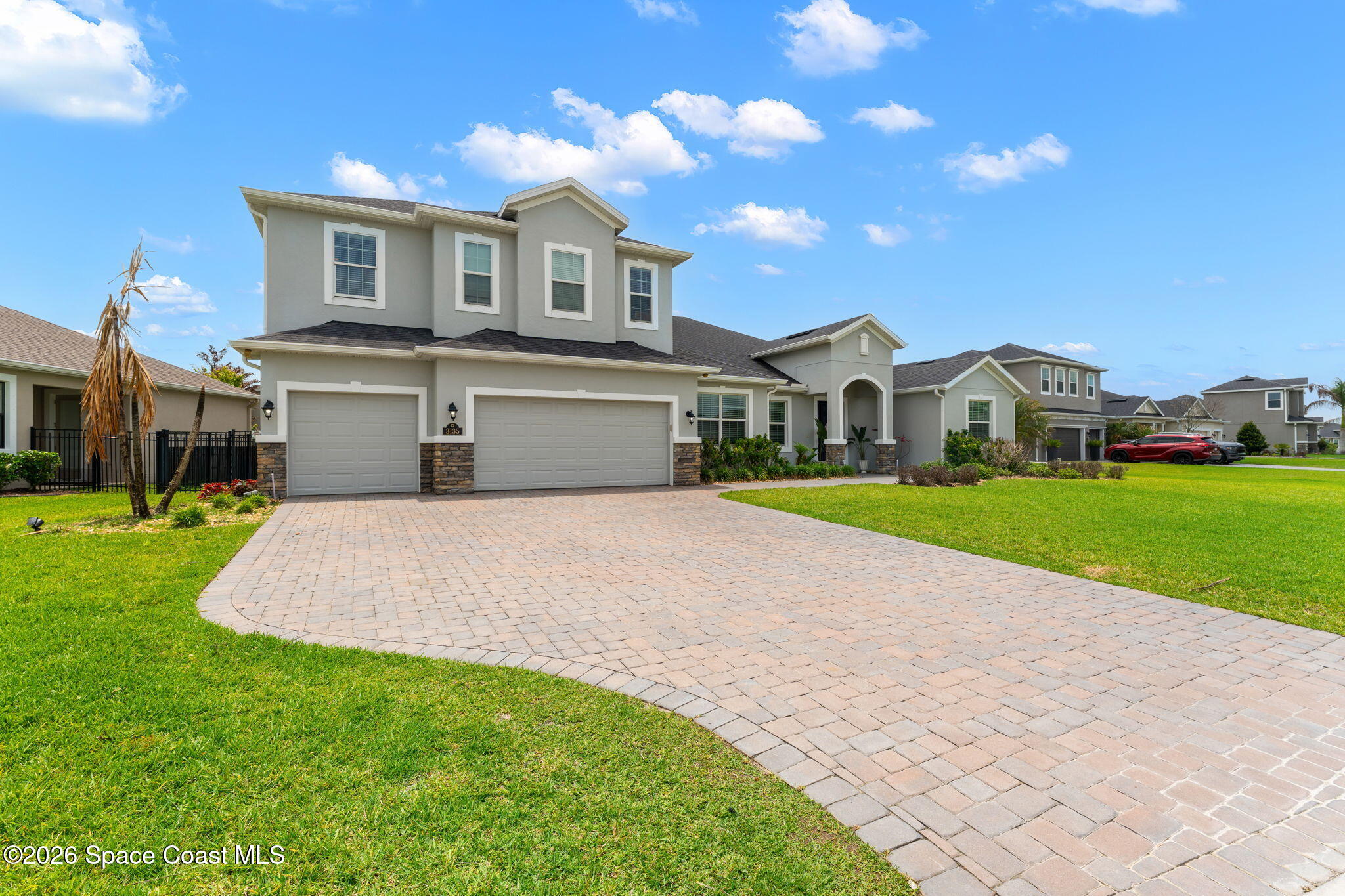 3135 Addison Drive Melbourne, FL 32940 - Photo 34 of 51 a front view of a house with a garden and yard