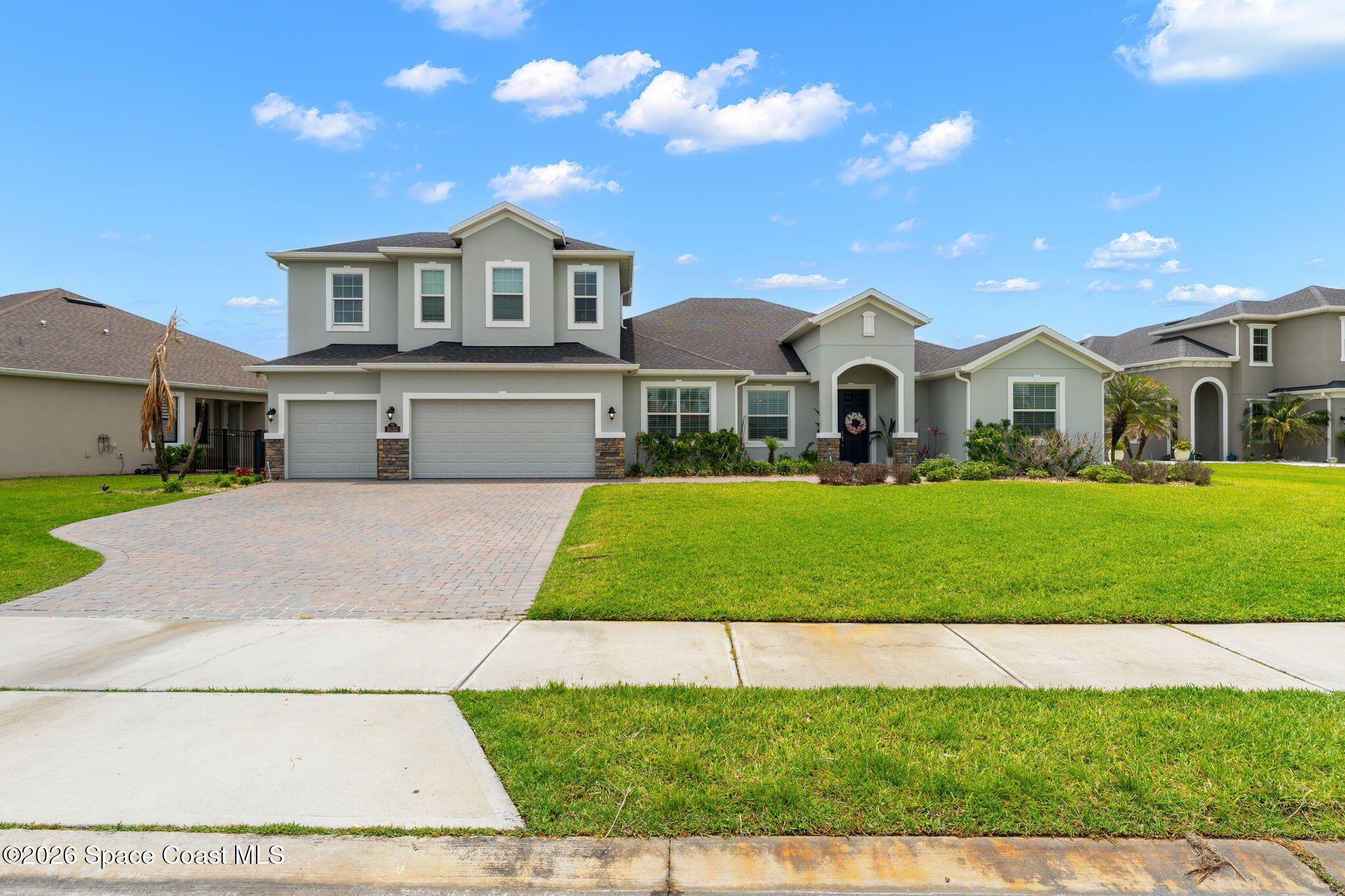 3135 Addison Drive Melbourne, FL 32940 - Photo 38 of 51 a front view of a house with a garden and trees
