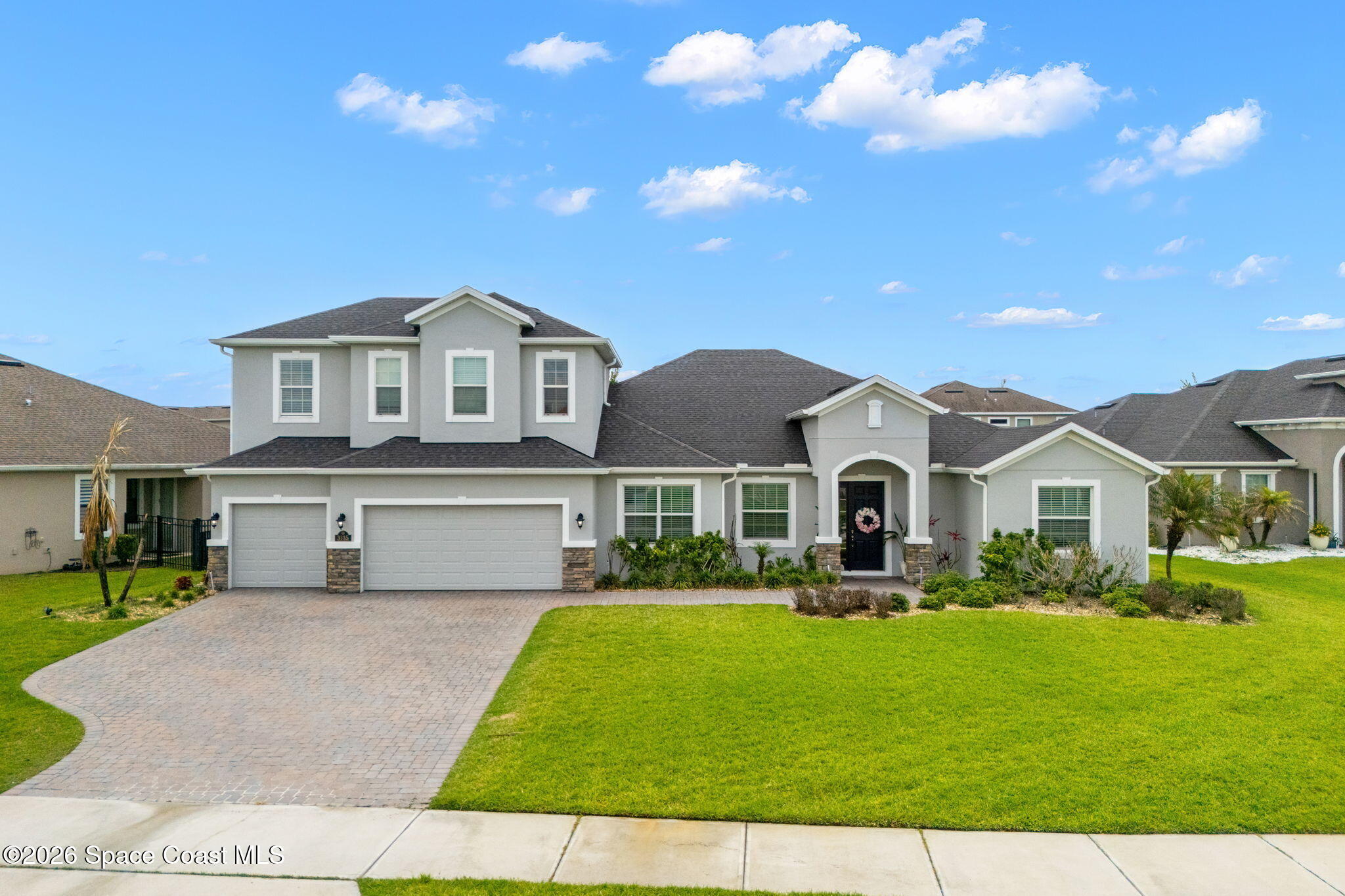 3135 Addison Drive Melbourne, FL 32940 - Photo 4 of 51 a front view of a house with a yard and trees