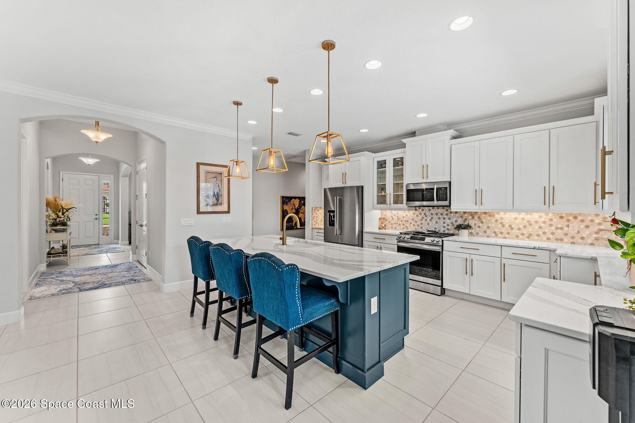3135 Addison Drive Melbourne, FL 32940 - Photo 7 of 51 a kitchen with kitchen island granite countertop lots of counter top space and stainless steel appliances