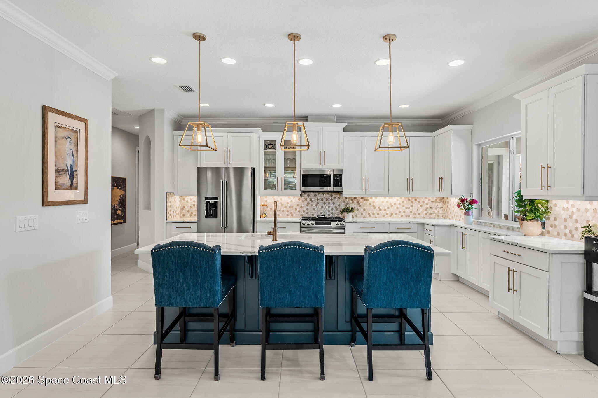 3135 Addison Drive Melbourne, FL 32940 - Photo 8 of 51 a kitchen with stainless steel appliances kitchen island granite countertop a table chairs and a refrigerator