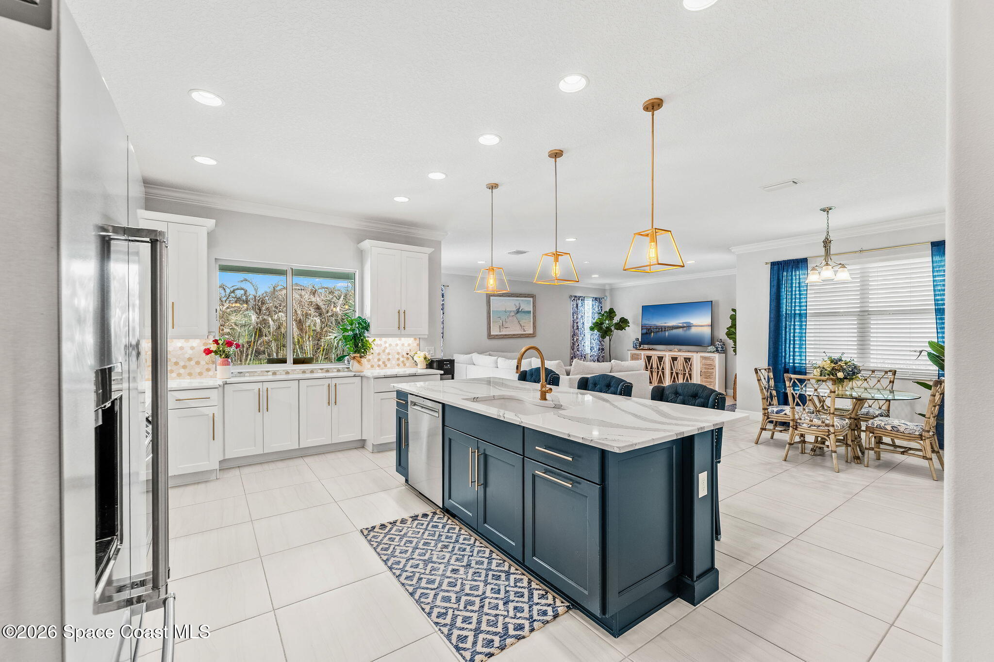 3135 Addison Drive Melbourne, FL 32940 - Photo 10 of 51 a room with stainless steel appliances kitchen island granite countertop a sink and cabinets