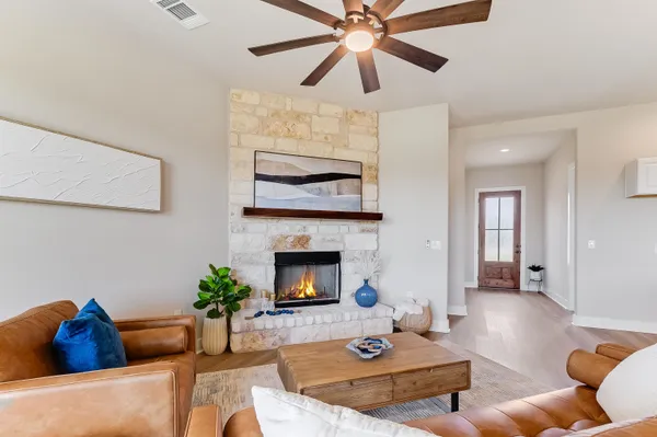 a living room with furniture and a fireplace