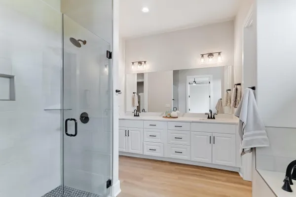 a bathroom with a shower sink and mirror