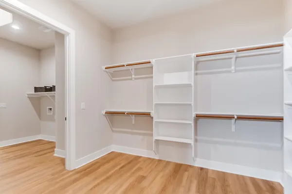a view of walk in closet with empty racks