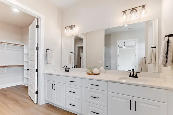 a bathroom with a double vanity sink and mirror