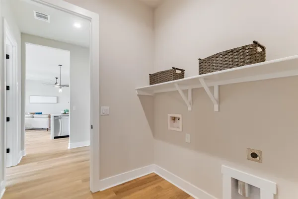 a view of a bedroom with wooden floor
