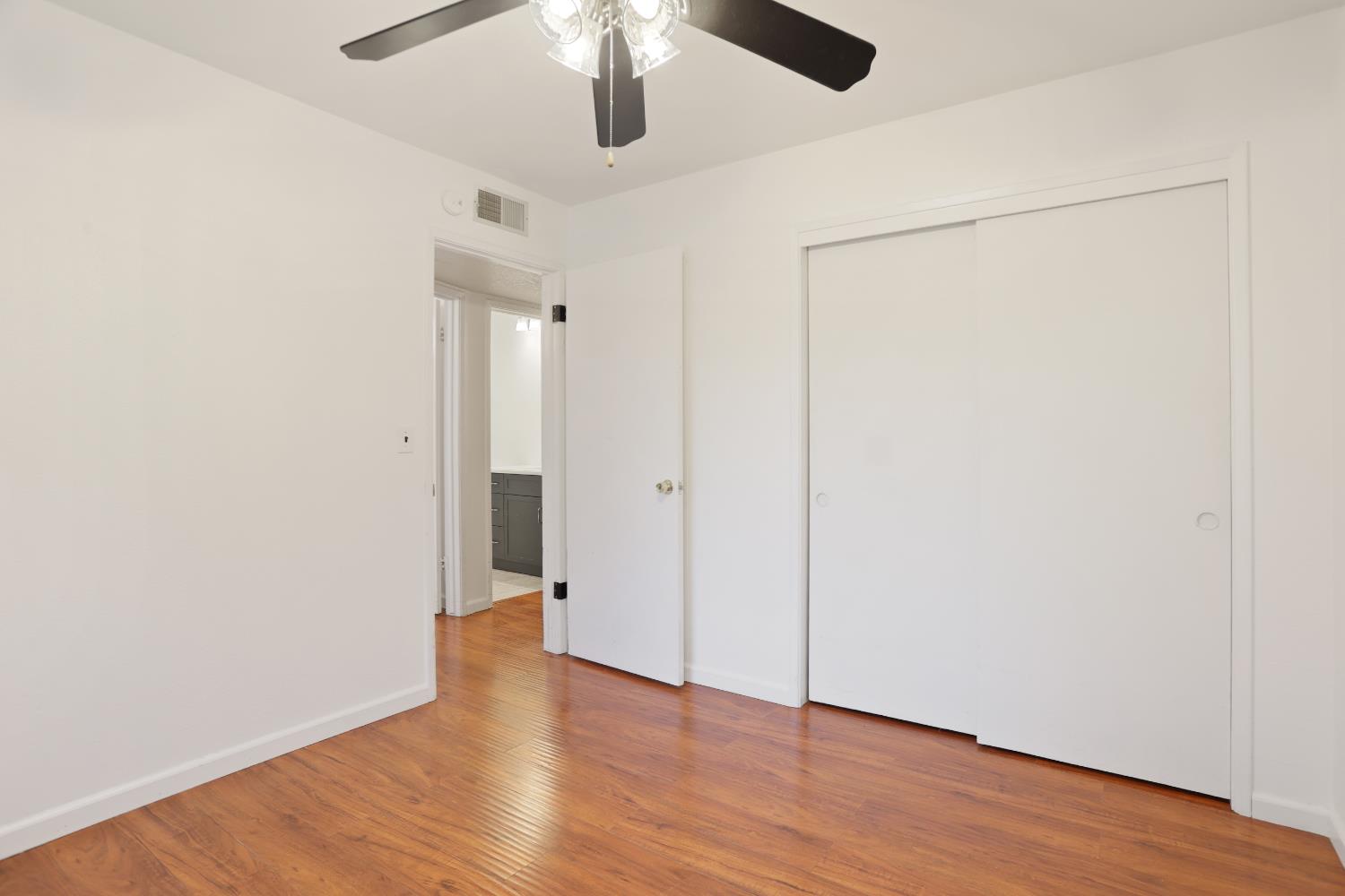 1417 Fransen Lane Modesto, CA 95355 - Photo 13 of 30 a view of an empty room with wooden floor