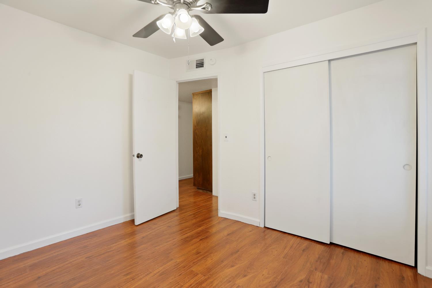 1417 Fransen Lane Modesto, CA 95355 - Photo 16 of 30 an empty room with wooden floor cabinet and windows