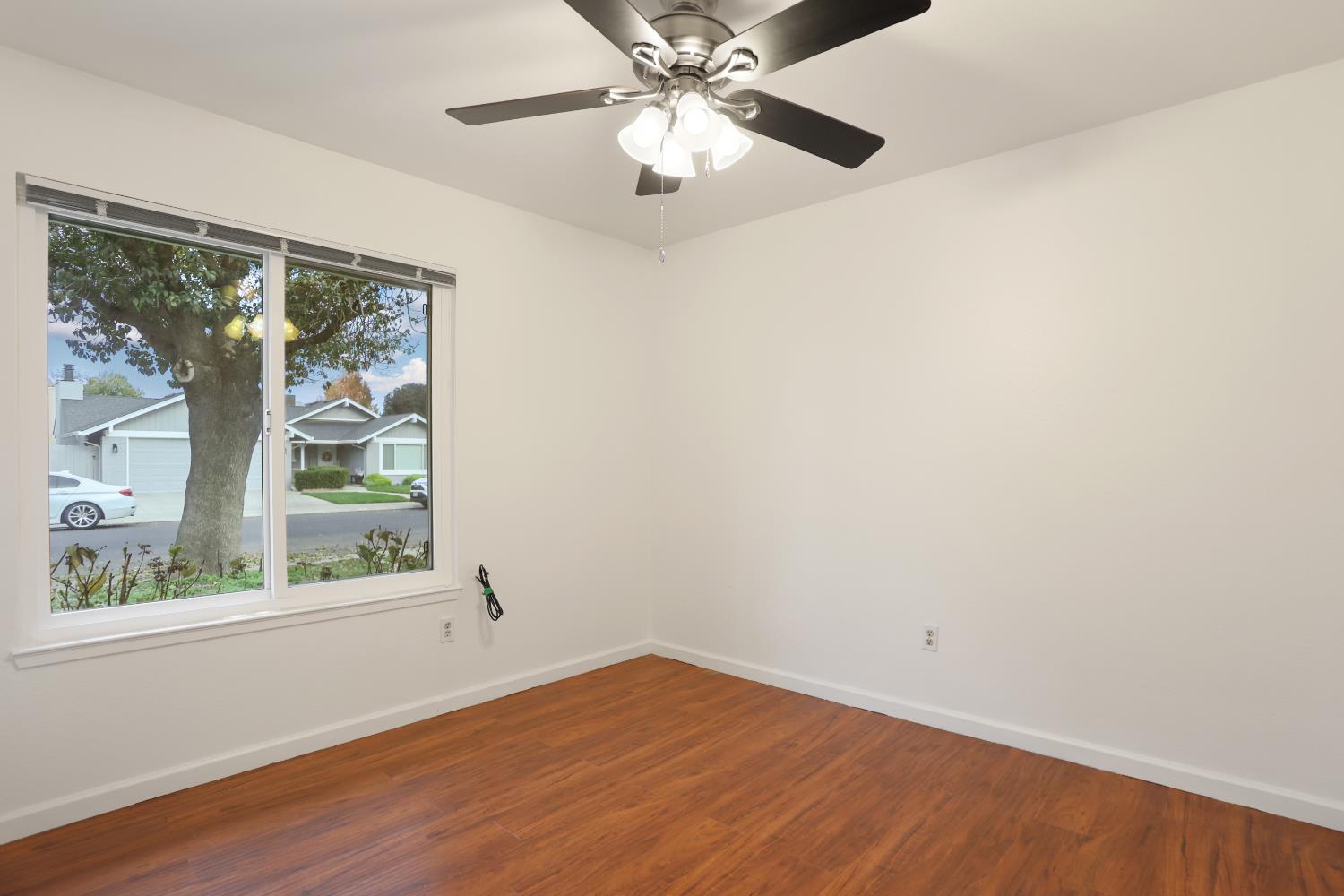 1417 Fransen Lane Modesto, CA 95355 - Photo 17 of 30 a view of an empty room with wooden floor and a window