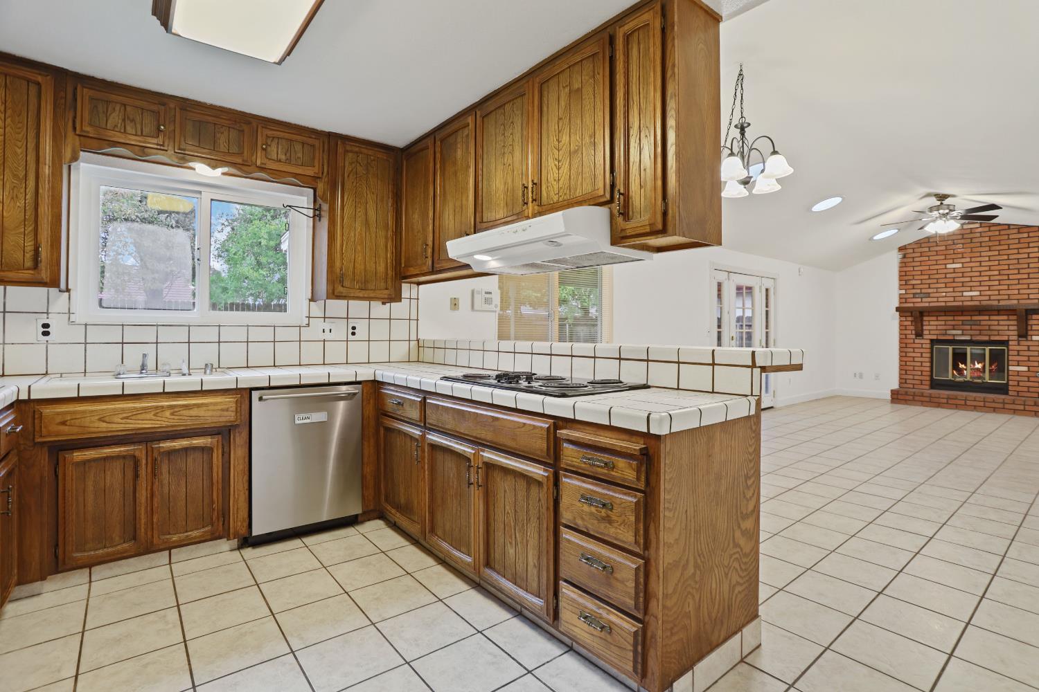 1417 Fransen Lane Modesto, CA 95355 - Photo 6 of 30 a kitchen with stainless steel appliances granite countertop a stove a sink and a microwave