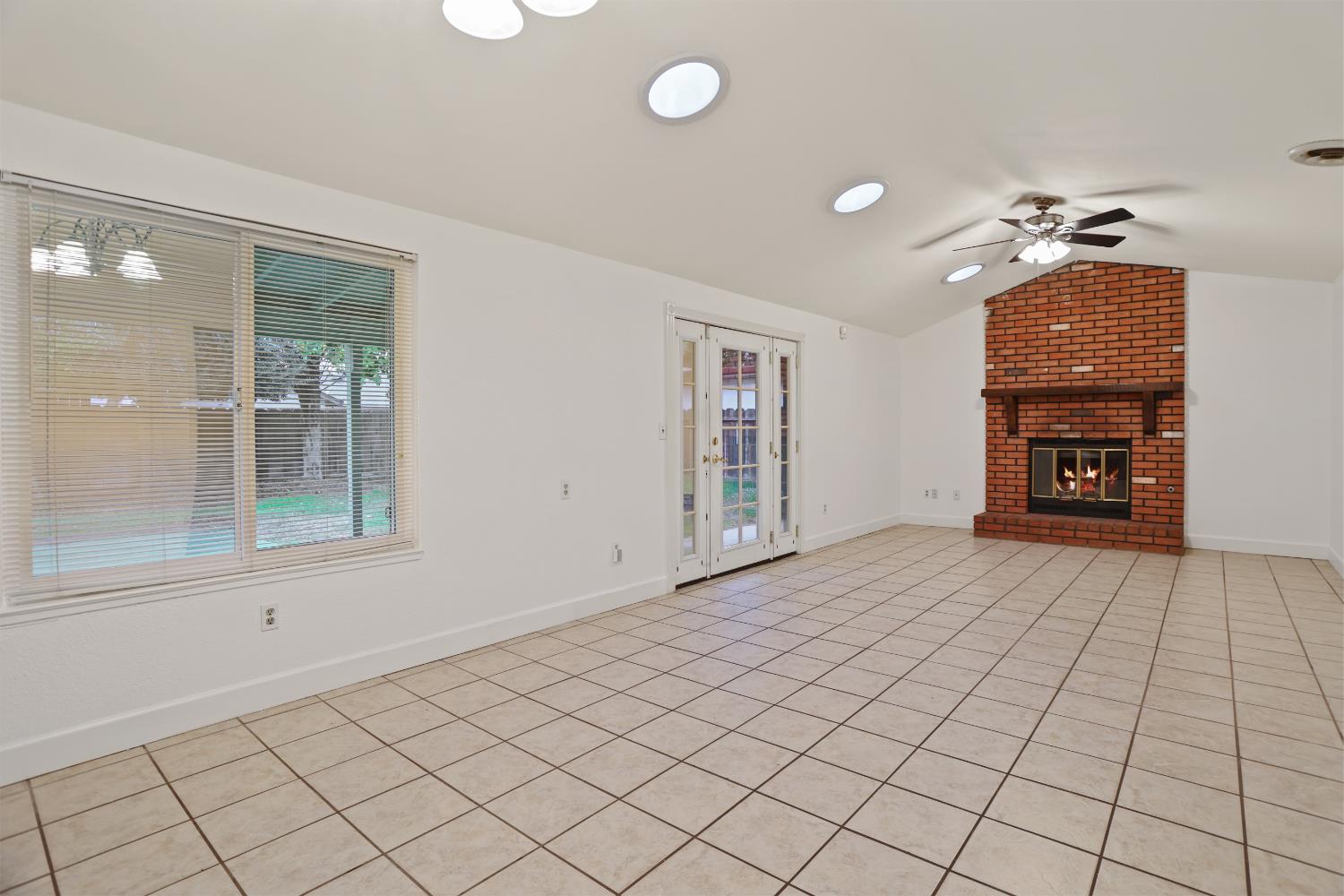1417 Fransen Lane Modesto, CA 95355 - Photo 9 of 30 an empty room with windows and fireplace