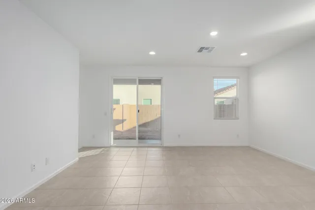 an empty room with windows and pillars in it