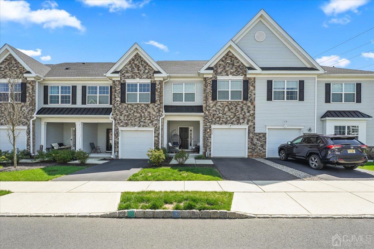 a front view of a house with a yard and garage