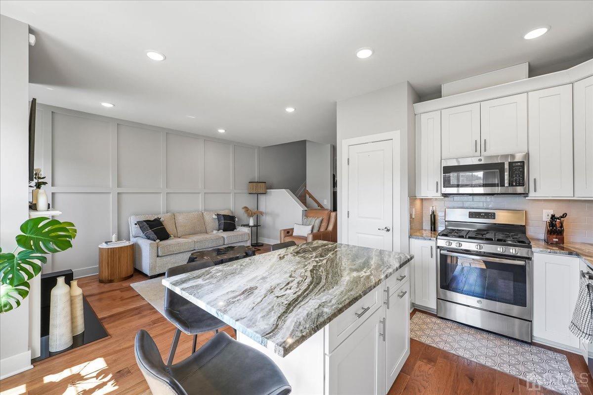 1404 Tavern Road Monroe Township, NJ 08831 - Photo 14 of 29 a kitchen with kitchen island granite countertop a sink cabinets and stainless steel appliances