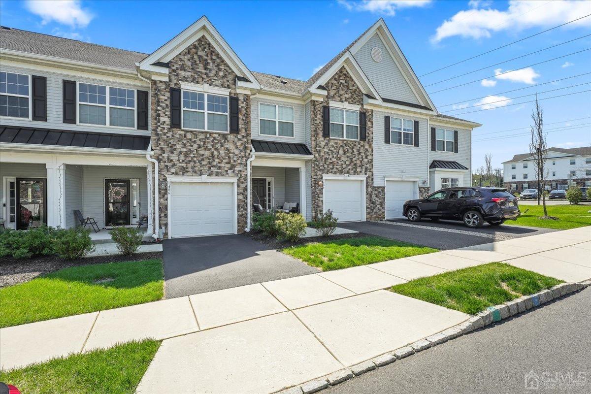 1404 Tavern Road Monroe Township, NJ 08831 - Photo 2 of 29 a front view of a house with a yard and garage