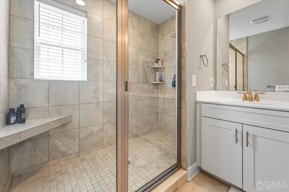 1404 Tavern Road Monroe Township, NJ 08831 - Photo 21 of 29 a bathroom with a shower sink and vanity