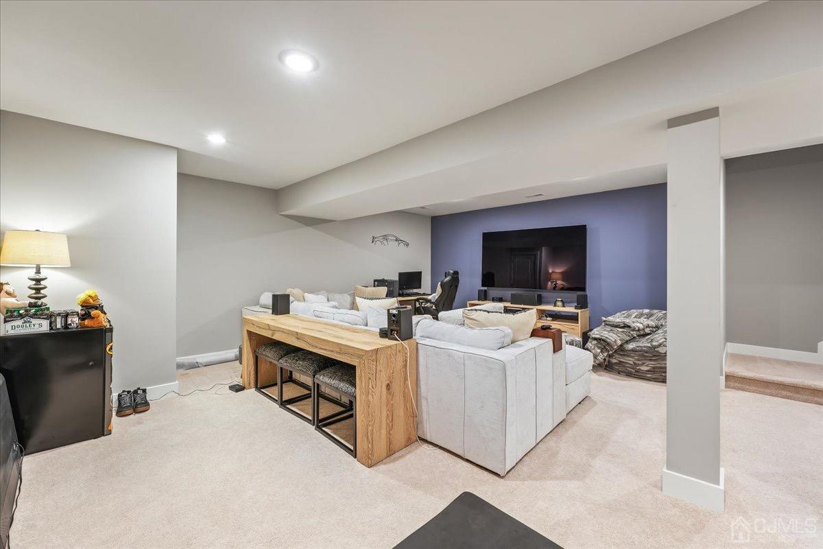 1404 Tavern Road Monroe Township, NJ 08831 - Photo 23 of 29 a view of living room with furniture a flat screen tv and a fireplace