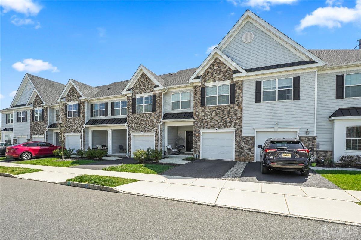 1404 Tavern Road Monroe Township, NJ 08831 - Photo 3 of 29 a front view of a house with a garden and yard