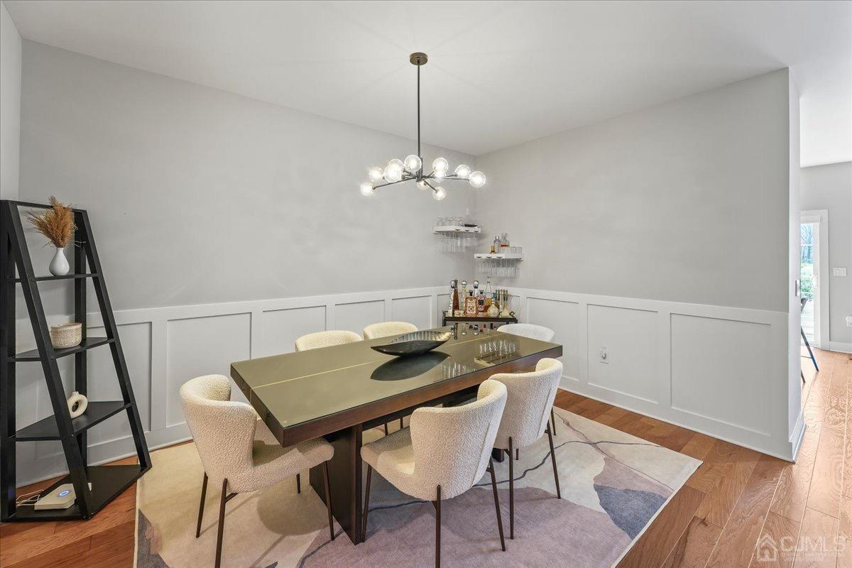 1404 Tavern Road Monroe Township, NJ 08831 - Photo 5 of 29 a view of a dining room with furniture and wooden floor