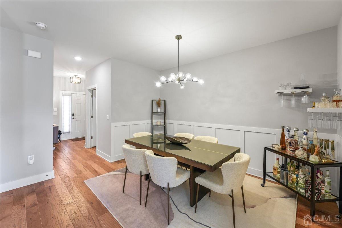 1404 Tavern Road Monroe Township, NJ 08831 - Photo 6 of 29 a view of a dining room with furniture and wooden floor