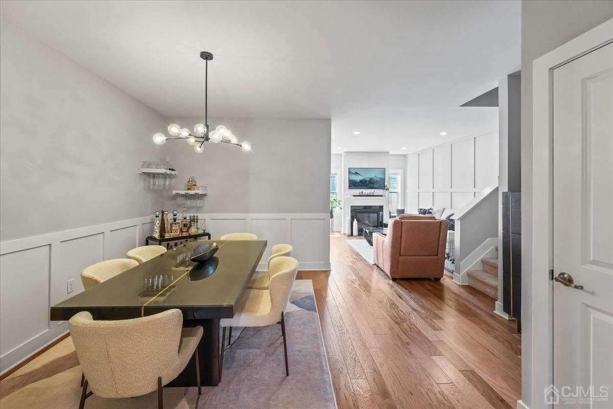 1404 Tavern Road Monroe Township, NJ 08831 - Photo 7 of 29 a view of a dining room with furniture a chandelier and wooden floor