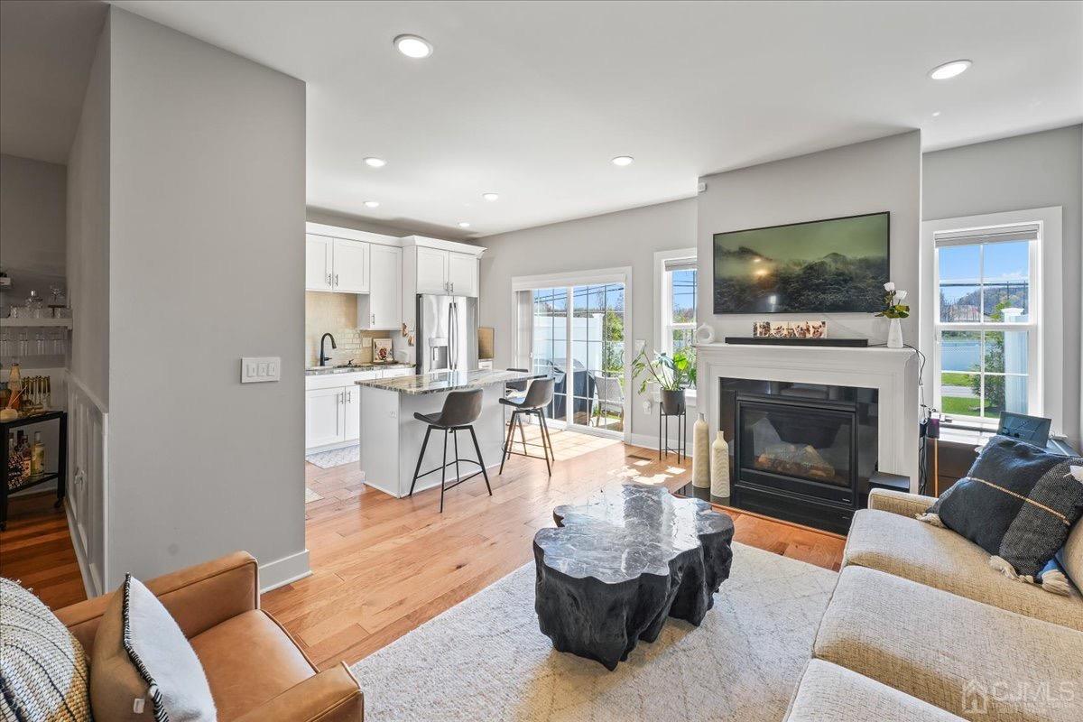1404 Tavern Road Monroe Township, NJ 08831 - Photo 9 of 29 a living room with furniture a flat screen tv and a fireplace