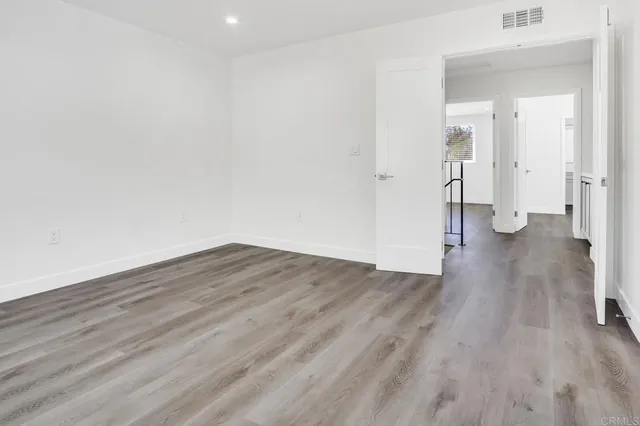a view of a room with wooden floor