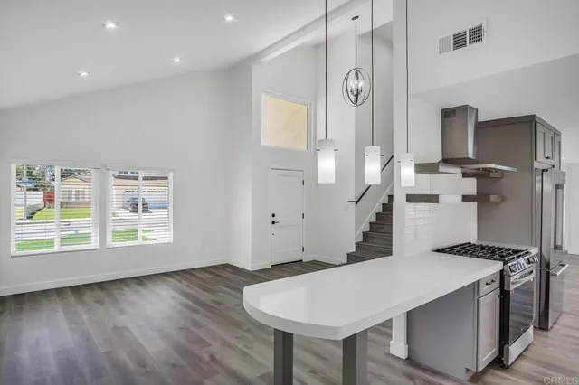 a spacious bathroom with a granite countertop sink and a mirror