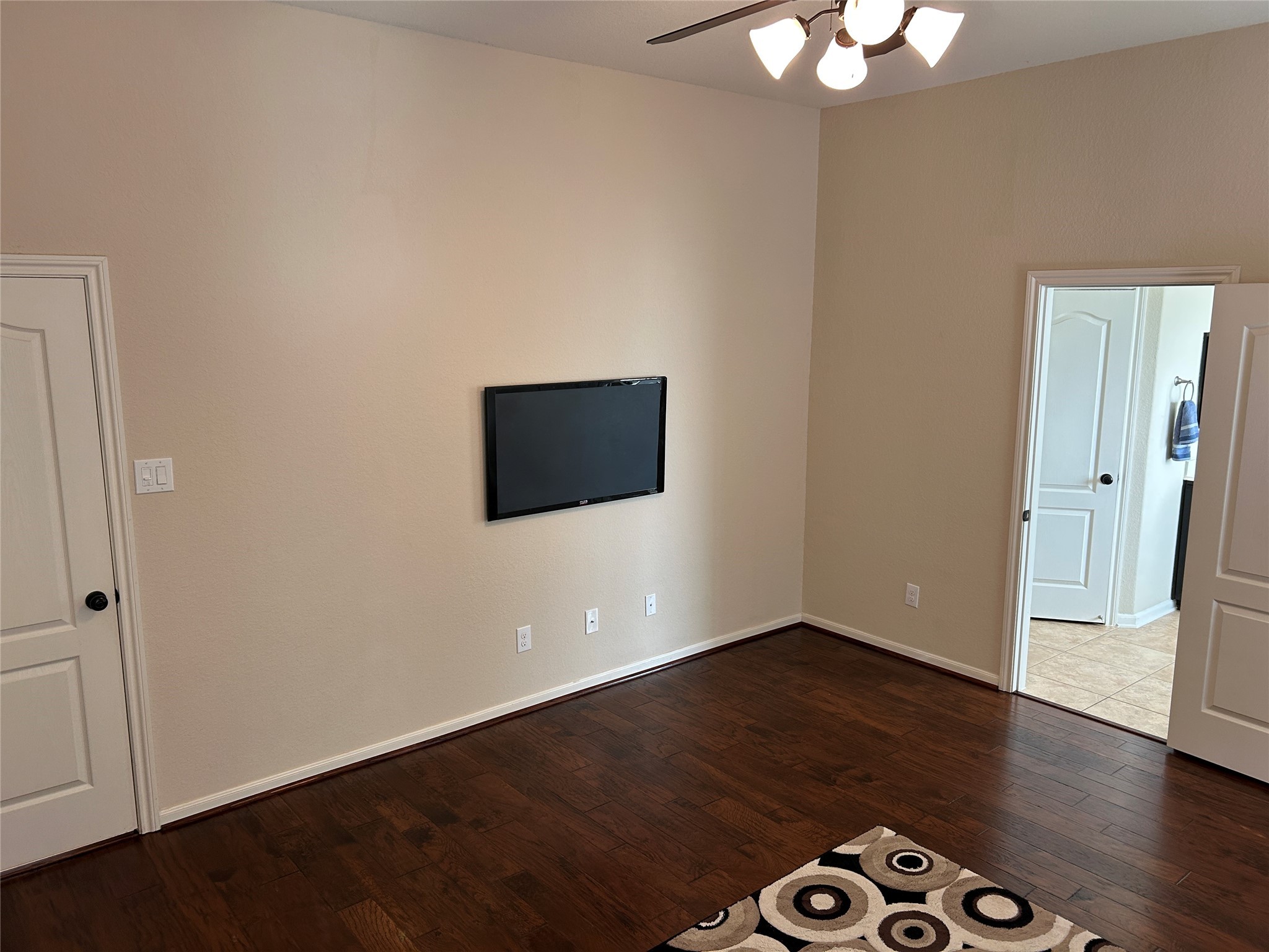 6819 Hunters Trace Lane Baytown, TX 77521 - Photo 18 of 32 an empty room with wooden floor and windows