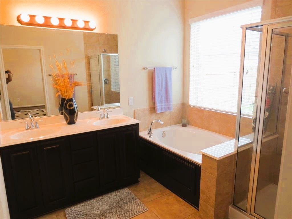 6819 Hunters Trace Lane Baytown, TX 77521 - Photo 19 of 32 a bathroom with a sink vanity and a mirror