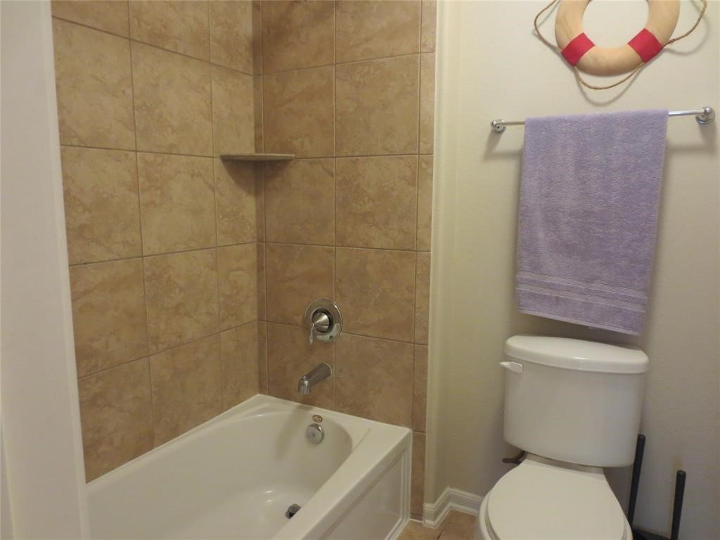 6819 Hunters Trace Lane Baytown, TX 77521 - Photo 26 of 32 a white toilet sitting next to a bath tub