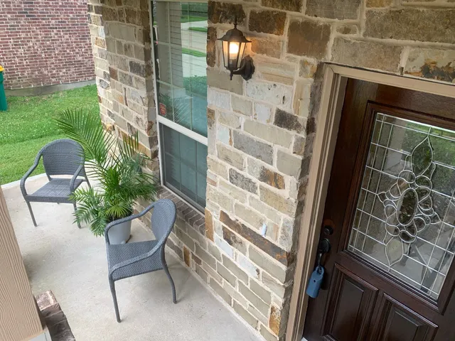 a view of balcony with couple of chairs