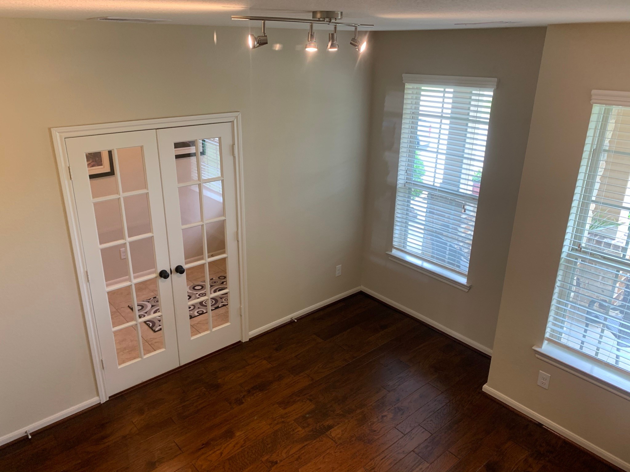 6819 Hunters Trace Lane Baytown, TX 77521 - Photo 5 of 32 a view of an empty room with wooden floor and a window