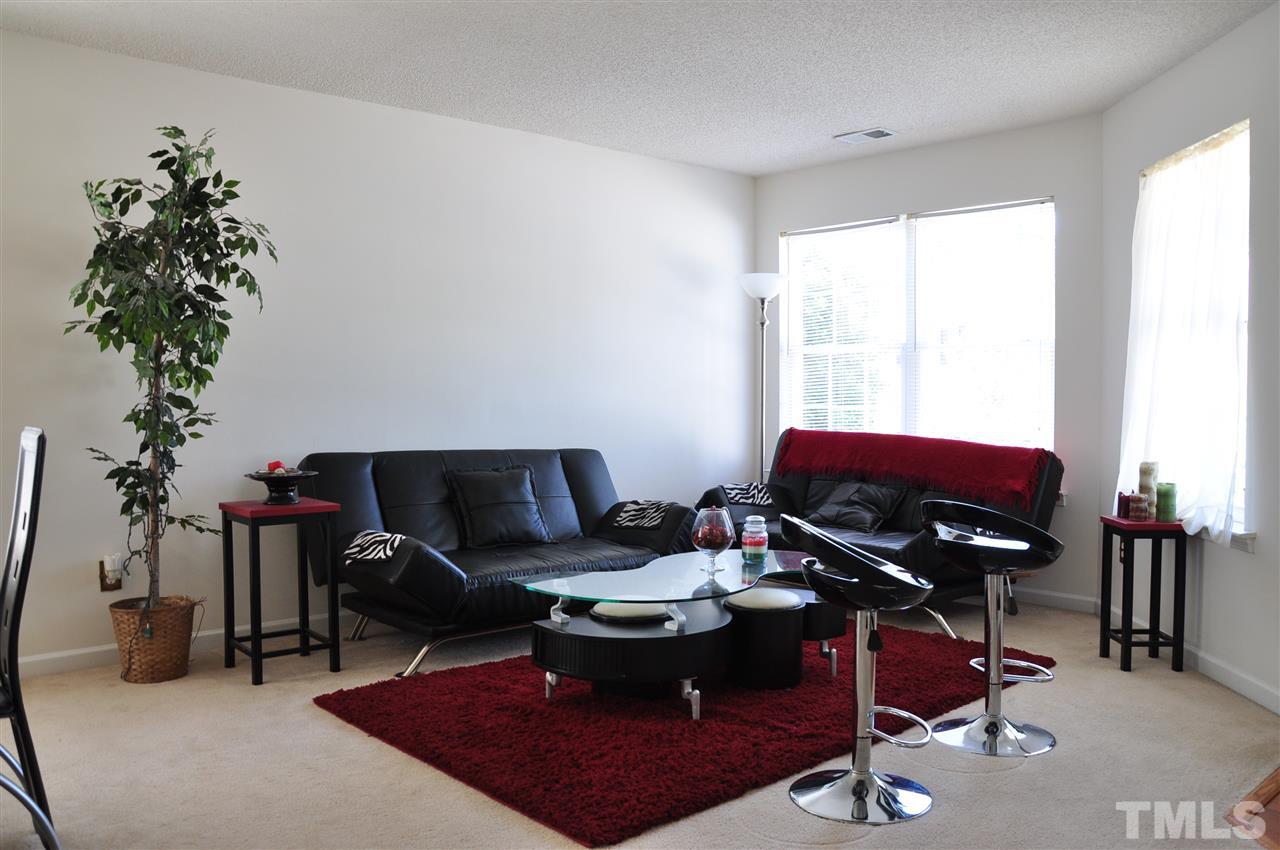 3305 Marcony Way Raleigh, NC 27610 - Photo 11 of 25 a living room with furniture a potted plant and a large window