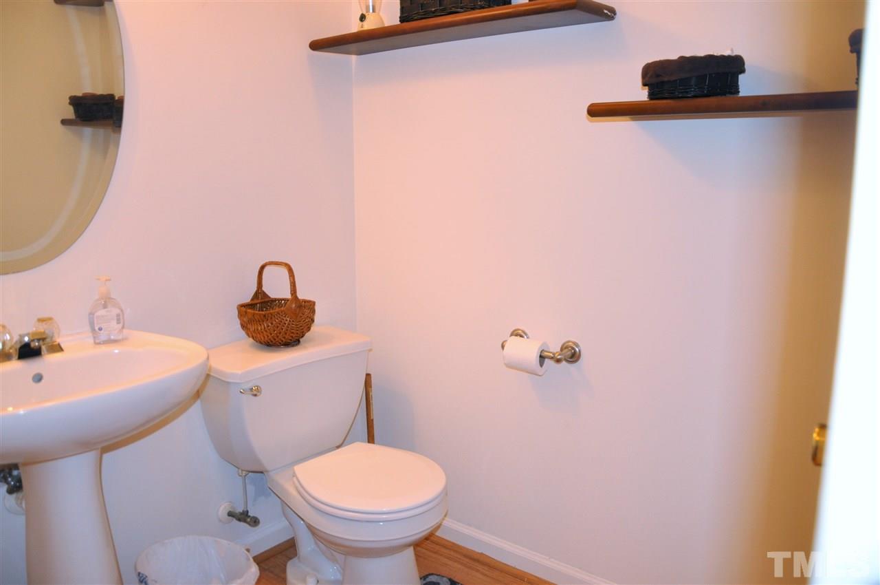 3305 Marcony Way Raleigh, NC 27610 - Photo 15 of 25 a bathroom with a sink and a toilet