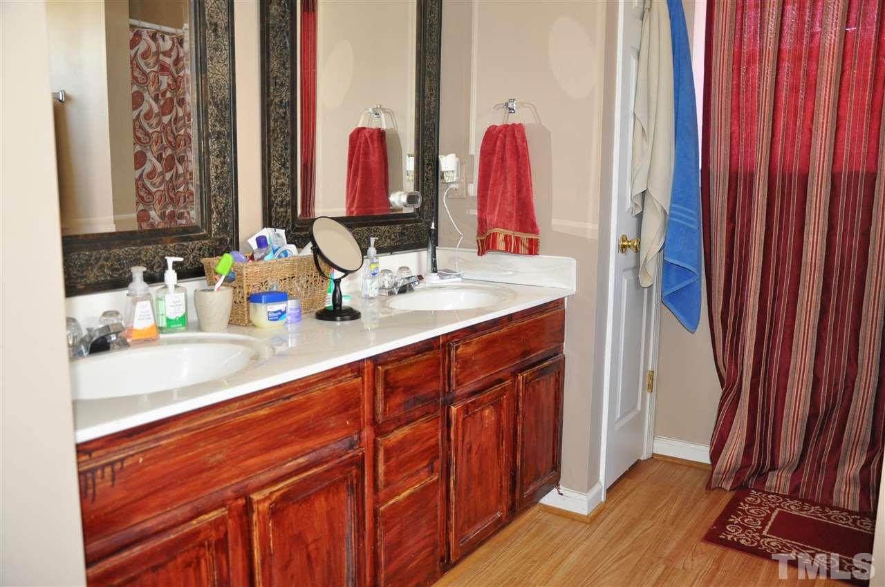 3305 Marcony Way Raleigh, NC 27610 - Photo 19 of 25 a bathroom with a sink vanity and a mirror