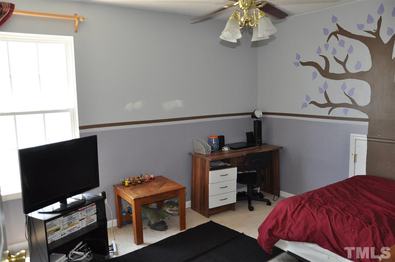 3305 Marcony Way Raleigh, NC 27610 - Photo 20 of 25 a bedroom with a bed and wooden floor