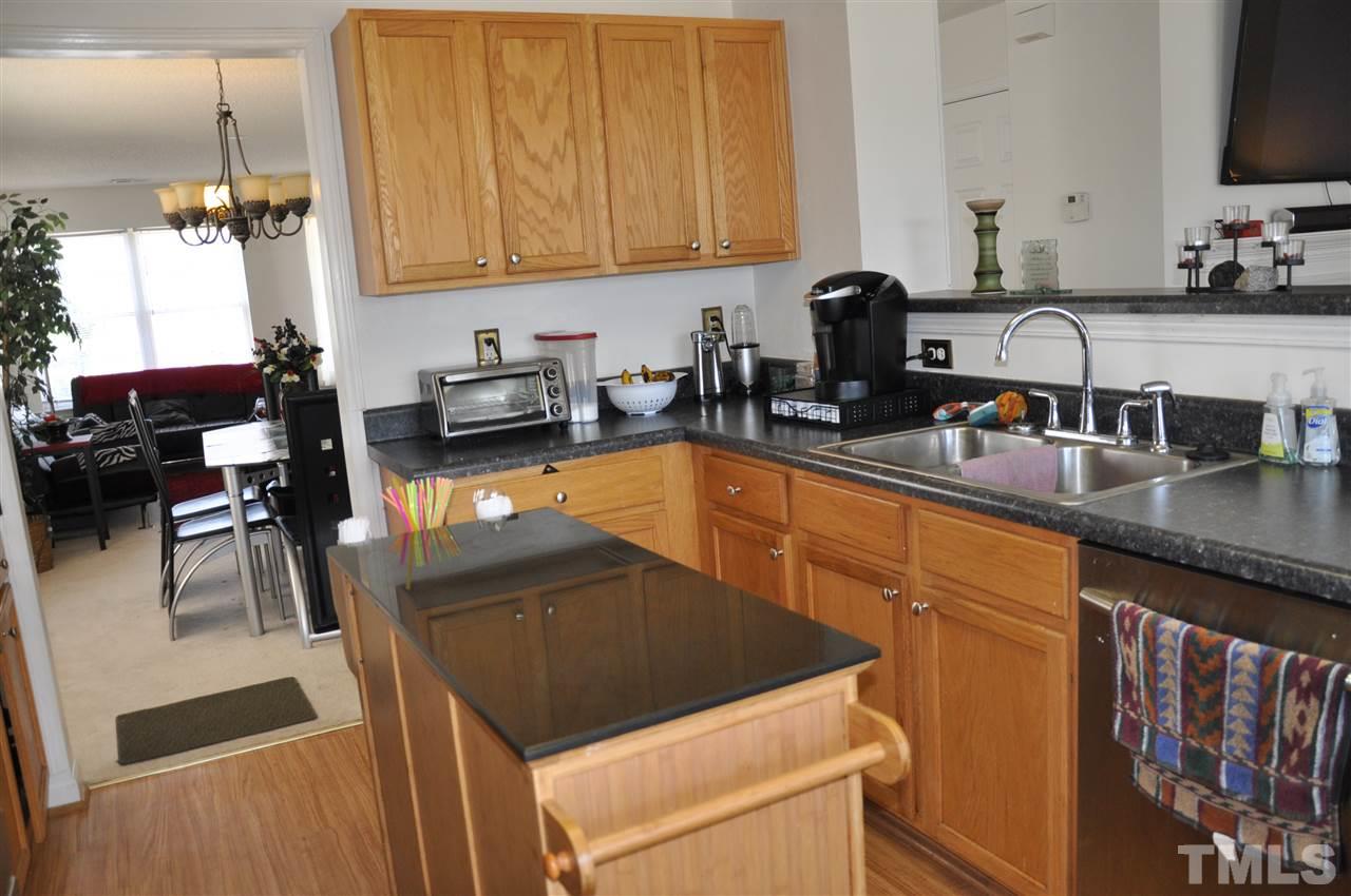 3305 Marcony Way Raleigh, NC 27610 - Photo 3 of 25 a kitchen with a sink a stove and a microwave