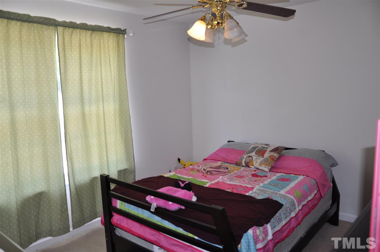 3305 Marcony Way Raleigh, NC 27610 - Photo 23 of 25 a bedroom with a bed and a chandelier